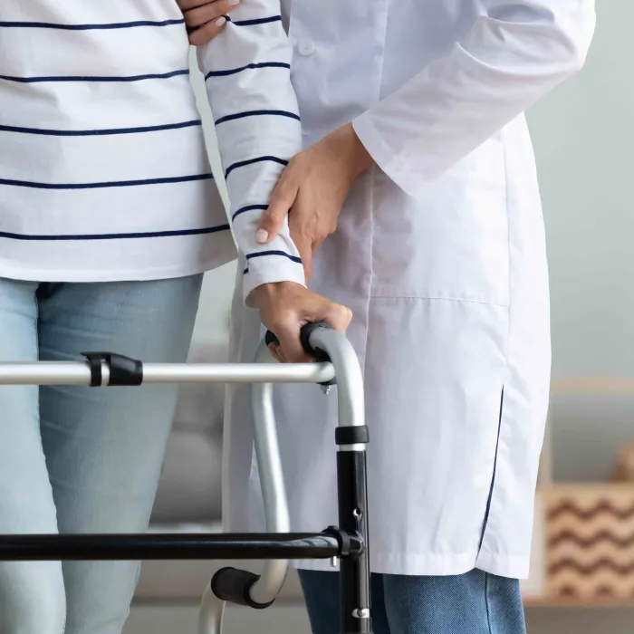 doctor helping patient rehab walking