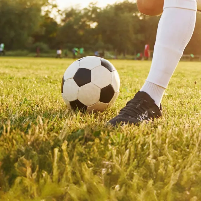 young adult playing soccer