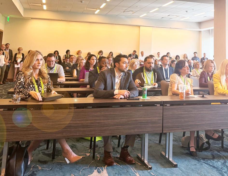 people at a conference listening to a presentation