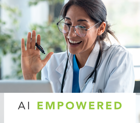 doctor at their desk waving to the screen as on a video conference